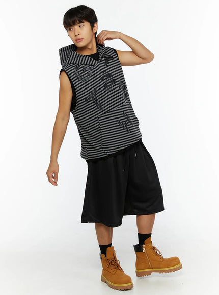 Men's Casual Jorts IL510 Black full-body side-angle shot on male model hand raised to collar dynamic pose showing wide leg drape