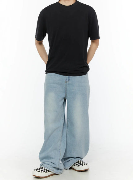 Men's Casual Relaxed Fit Jeans IL509 Ice blue front three-quarter view on model showing wide-leg denim silhouette with faded wash texture, styled with black tee and checkered slip-ons