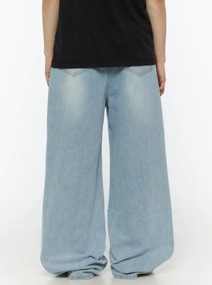 Men's Casual Relaxed Fit Jeans IL509 Ice blue back close-up on model showing V-shaped back pocket stitching, wide-leg hem pooling, light faded denim texture