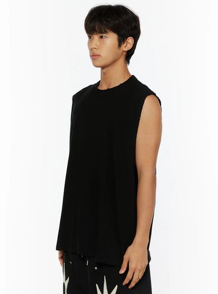 Men's Casual Sleeveless Top IL510 Black side shot on male model looking left, showing raw-edge armhole and relaxed silhouette with graphic shorts