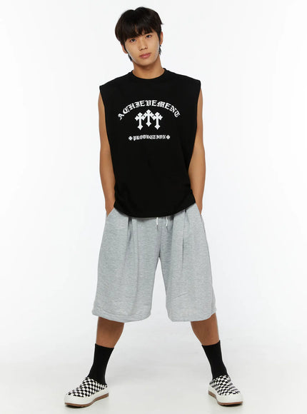Men's Casual Sweat Shorts IL510 gray full-body front shot on male model standing straight, hands in pockets, styled with black sleeveless graphic tee and checkered shoes