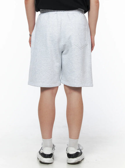 Men's Casual Sweat Shorts (Light Gray) IL502 Light Gray back view on model showing single back patch pocket, elastic waistband, relaxed wide-leg silhouette, heathered fleece fabric