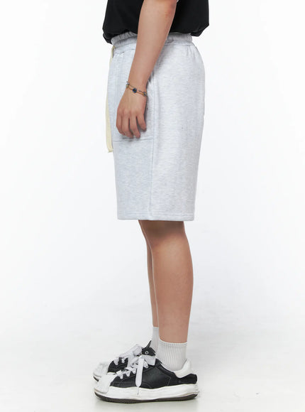 Men's Casual Sweat Shorts (Light Gray) IL502 Light Gray side-only close-up on model showing elastic waistband, hanging cream drawstring, side seam and heathered fleece texture detail