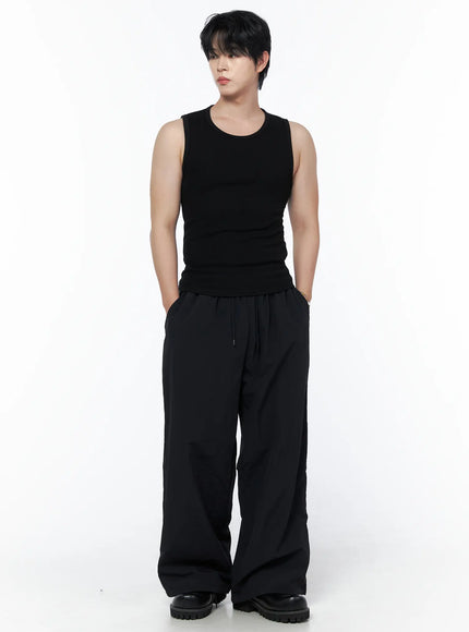 LEWKIN Men's Casual Tank IL502 Black S/M front view on model styled with wide-leg black trousers and chunky boots, hands in pockets