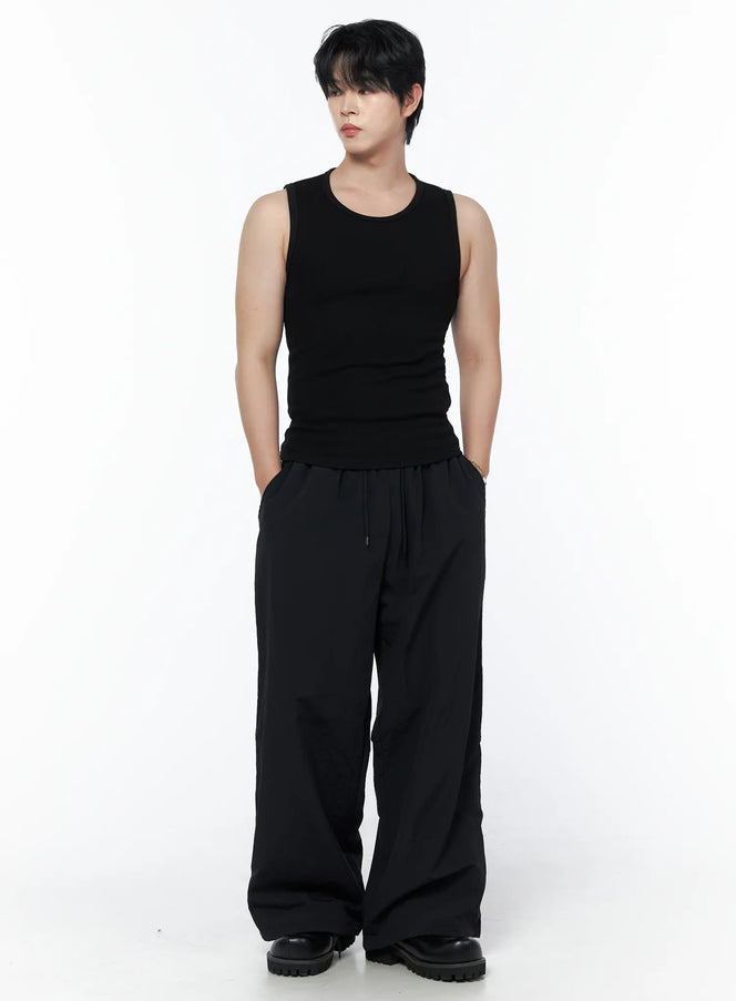 LEWKIN Men's Casual Tank IL502 Black S/M front view on model styled with wide-leg black trousers and chunky boots, hands in pockets