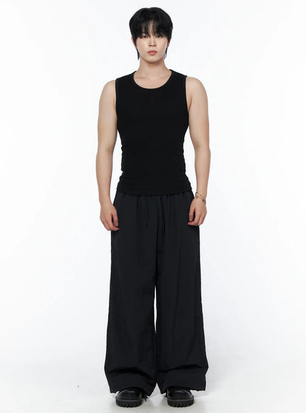 Men's Casual Tank IL502 Black front view on model standing upright with wide-leg black trousers, arms at sides