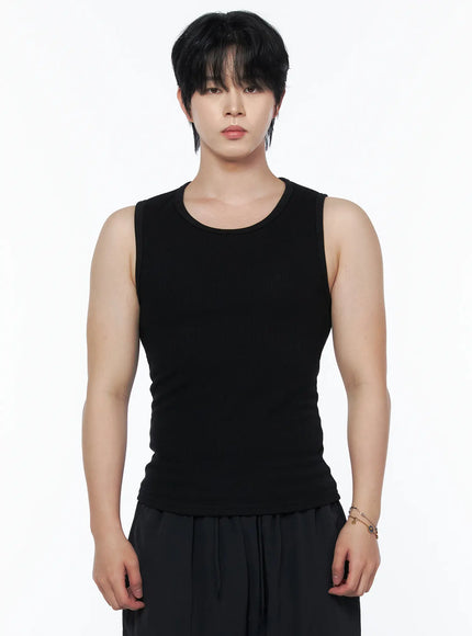 Men's Casual Tank IL502 Black front close-up view on model highlighting ribbed knit fabric and U-neckline, paired with black trousers