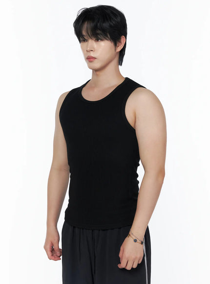 Men's Casual Tank IL502 Black side view close-up on model showing ribbed texture, U-neckline, and fitted silhouette with striped pants