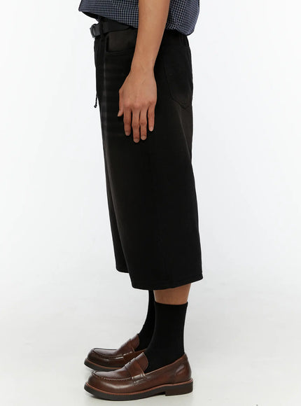 Men's Casual Wide Fit Jorts IL510 Black side profile view on model revealing wide culotte-length leg, back pocket, and loafers from left side