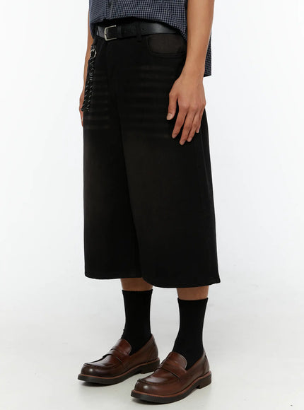 Men's Casual Wide Fit Jorts IL510 Black three-quarter side view on model showing wide-leg silhouette, rope chain detail, belt, and brown loafers