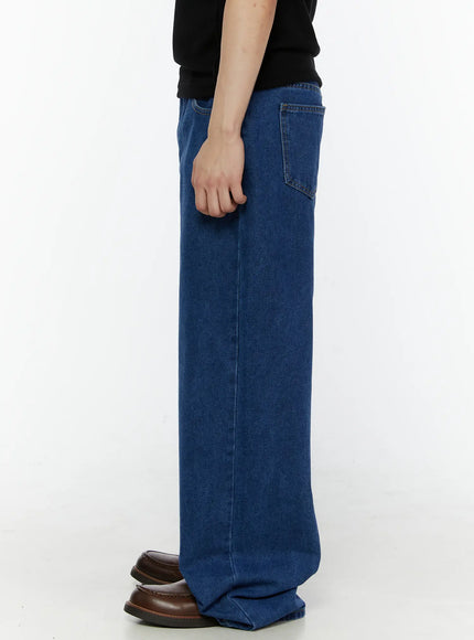 Men's Casual Wide Leg Jeans IL509 Blue side shot on model in black sweatshirt, revealing back pocket placement and full-length wide-leg denim drape
