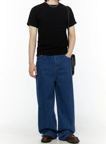 Men's Casual Wide Leg Jeans IL509 Blue full-body front shot on male model in black ribbed tee with crossbody bag, hand in pocket, standing pose
