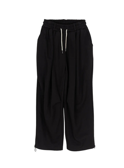 Men's Curved Fit Sweatpants (Black) IL502 black flat-lay front view showing elastic waistband cream drawstring wide-leg cut and hem zip details