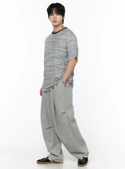 Men's Curved Fit Sweatpants (Gray) IL502 gray three-quarter side shot on male model styled with striped tee and black sneakers