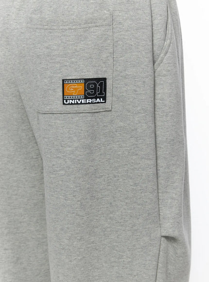 Men's Curved Fit Sweatpants (Gray) IL502 gray close-up detail of GT 91 Universal woven patch badge on side cargo pocket