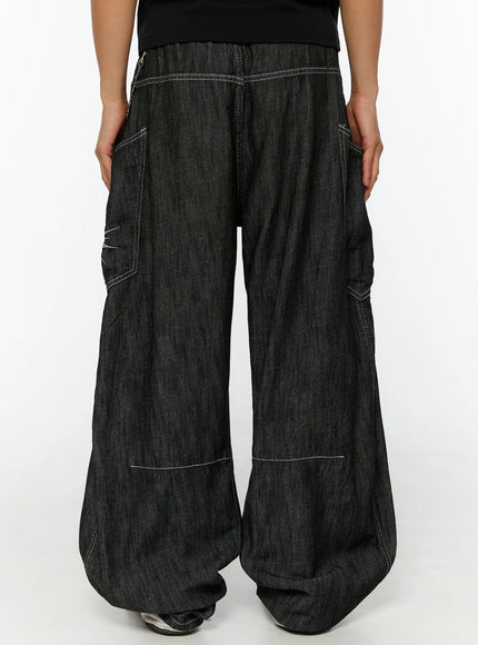 Men's Dale Embroidered Baggy Jeans IL509 black back view on female model showing wide-leg silhouette contrast stitching and rear cargo pockets