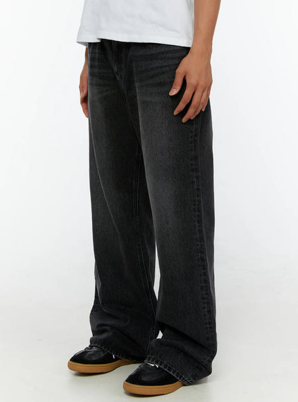 Men's Dark Wash Flare Jeans IL513 Black side view close-up on model showing wide-leg flare silhouette and inseam detail with stacked hem