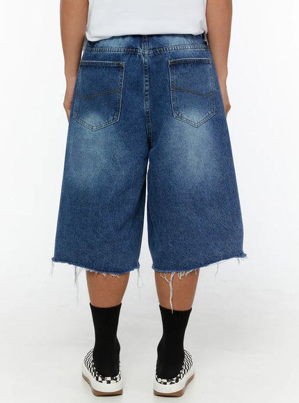 Men's Distressed Jorts IL509 Blue back view on model showing dual back pockets with contrast stitching and raw frayed hem on wide-leg denim