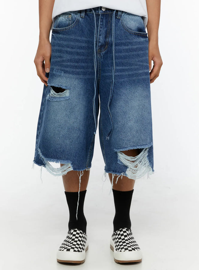 LEWKIN Men's Distressed Jorts IL509 Blue front crop view on model showing ripped holes and frayed raw hem denim shorts size M/L
