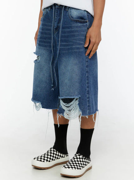Men's Distressed Jorts IL509 Blue close-up side view on model highlighting distressed rip detail and dangling drawstring on washed denim