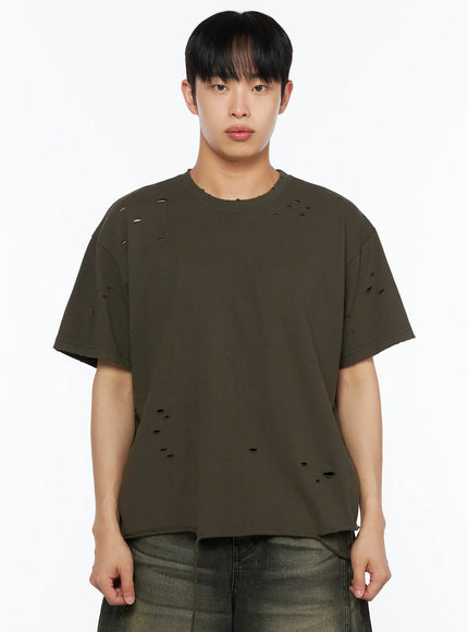 Men's Distressed Tee IL514 Khaki close-up front shot on male model showing scattered distressed cutout holes, frayed neckline, raw cut sleeve hem