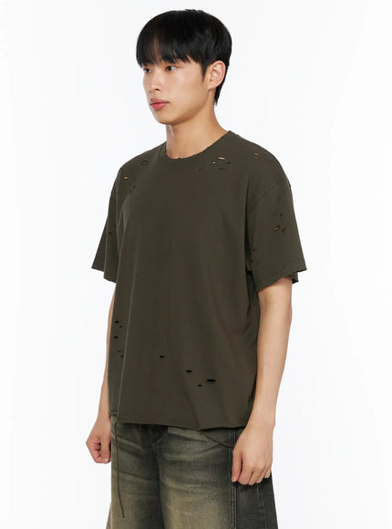 Men's Distressed Tee IL514 Khaki side shot on male model showing distressed hole detail, raw cut hem, relaxed boxy fit