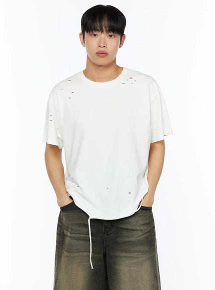Men's Distressed Tee IL514 White front shot on male model hands in pockets, distressed holes at chest and body, raw hem with drawstring detail