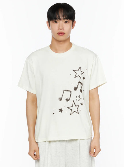 Men's Drawing Graphic Tee IL514 Light yellow close-up front shot on male model showing brown sketched star and music note graphic print, crew neck