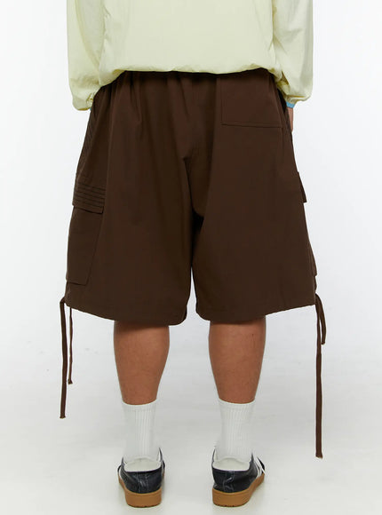 Men's Drawstring Cargo Shorts IL515 Brown back shot on model showing elastic waistband rear pocket cargo pockets and dangling drawstring ties