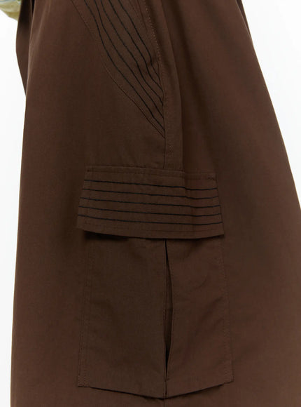 Men's Drawstring Cargo Shorts IL515 Brown close-up detail of ribbed pintuck cargo pocket flap and topstitching on brown woven fabric