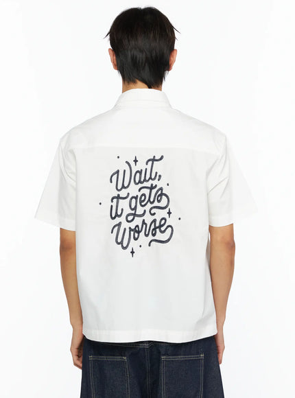 Men's Embroidered Button-Up Shirt IL528 White close-up back shot on model showing Wait it gets Worse cursive embroidery with dot and sparkle detailing