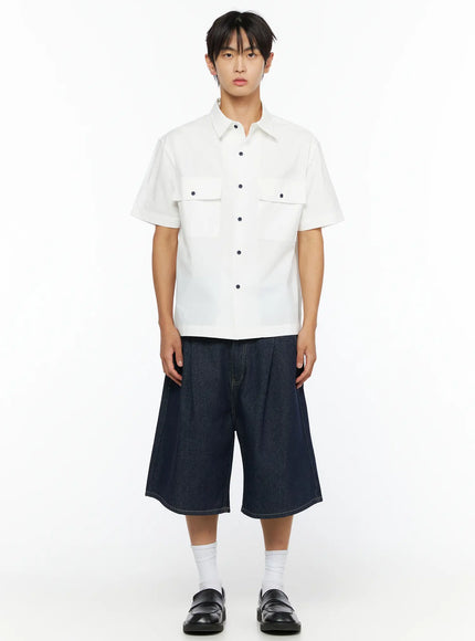 Men's Embroidered Button-Up Shirt IL528 White front shot on model full-length view showing dual chest flap pockets and navy snap buttons with denim shorts