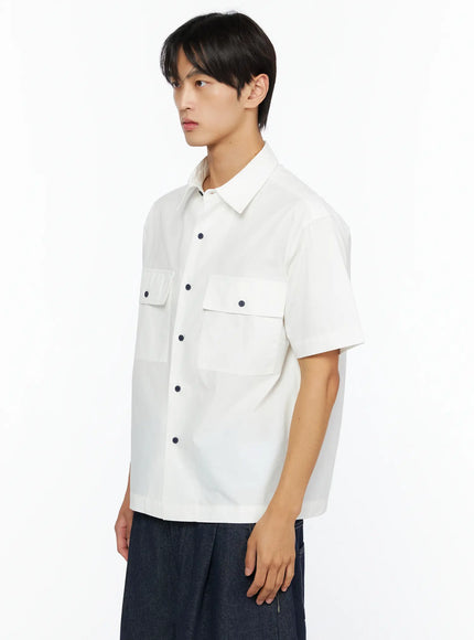 Men's Embroidered Button-Up Shirt IL528 White side shot on model showing dual flap chest pockets navy snap buttons and relaxed boxy silhouette