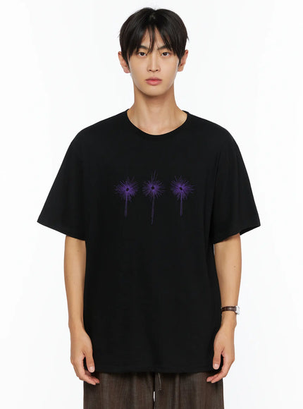 Men's Embroidered Graphic Tee IL528 Black front shot on male model direct gaze three purple starburst embroidery oversized drop-shoulder crew neck tee