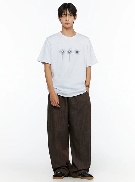 Men's Embroidered Graphic Tee IL528 Light Gray full-body front shot on male model relaxed standing arms at sides three starburst embroidery wide-leg pants styling