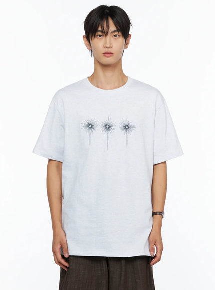 Men's Embroidered Graphic Tee IL528 Light Gray close-up front shot on male model upper-body crop showing three navy starburst embroidery detail on melange fabric