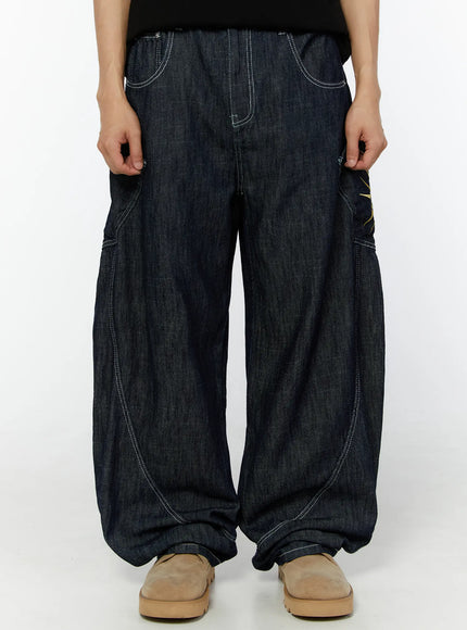 LEWKIN Men's Embroidered Wide Leg Jeans IU529 Dark blue front view on model, cropped waist-down, relaxed balloon-leg denim with white contrast stitching