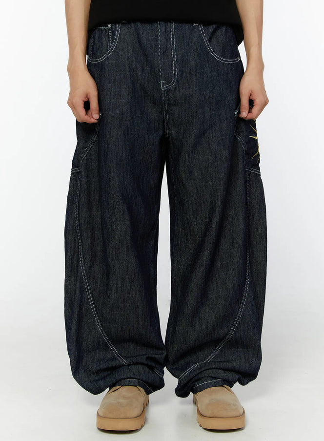 LEWKIN Men's Embroidered Wide Leg Jeans IU529 Dark blue front view on model, cropped waist-down, relaxed balloon-leg denim with white contrast stitching