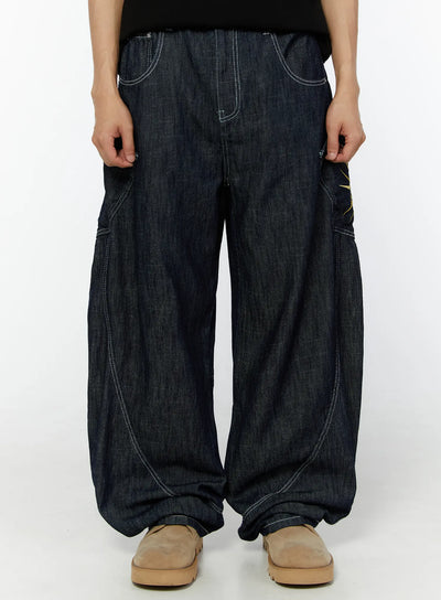 LEWKIN Men's Embroidered Wide Leg Jeans IU529 Dark blue front view on model, cropped waist-down, relaxed balloon-leg denim with white contrast stitching