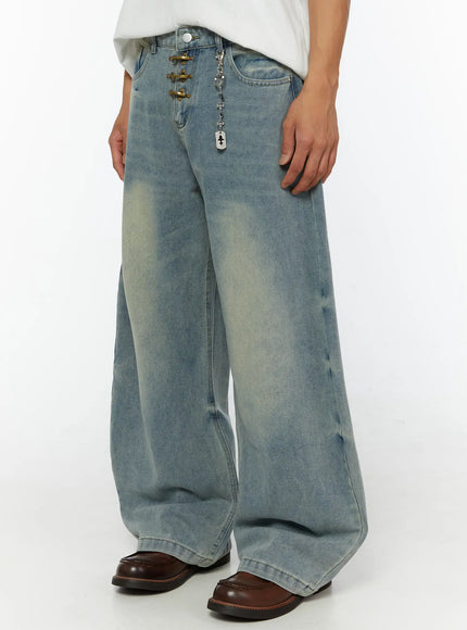 Men's Fireman Clasp Baggy Jeans IL507 Light blue angled front view on male model showing brass clasp fly, silver dog-tag chain, and wide-leg washed denim silhouette