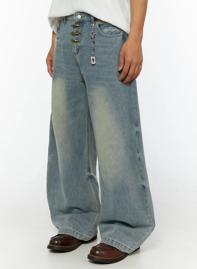 Men's Fireman Clasp Baggy Jeans IL507 Light blue angled front view on male model showing brass clasp fly, silver dog-tag chain, and wide-leg washed denim silhouette