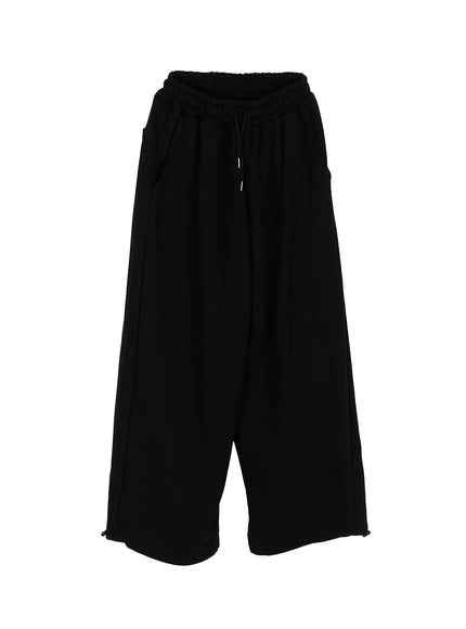 Men's Flame Wide Sweatpants (Black) IL514 flat-lay front view showing elastic drawstring waist, side pockets, wide-leg silhouette, and hem cinch toggles