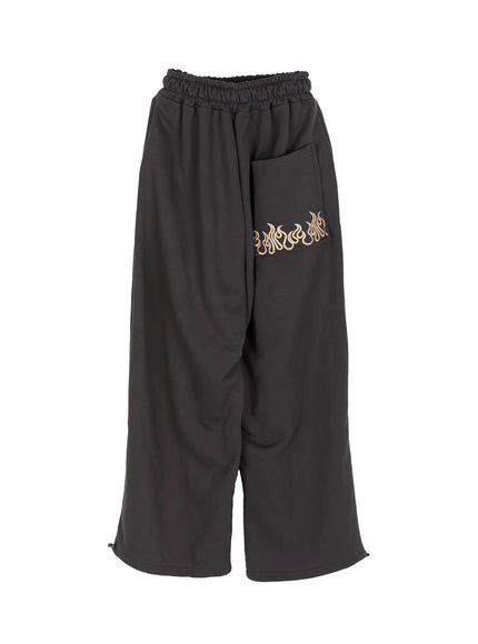 Men's Flame Wide Sweatpants (Dark Gray) IL514 Dark gray flat-lay back view showing gold flame embroidery on back patch pocket, elastic waist and ankle zip hem