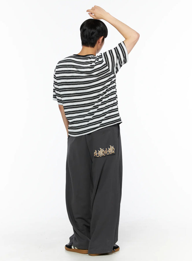 Men's Flame Wide Sweatpants (Dark Gray) IL514 Dark gray full back view on male model with raised arm, wide-leg silhouette styled with stripe tee