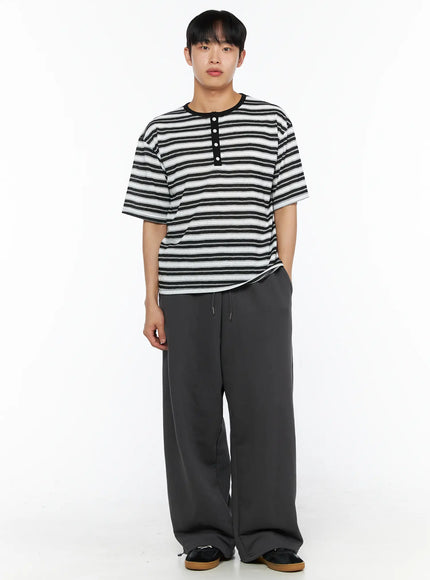 Men's Flame Wide Sweatpants (Dark Gray) IL514 Dark gray front full-body view on male model with hand in pocket, styled with stripe henley tee and sneakers
