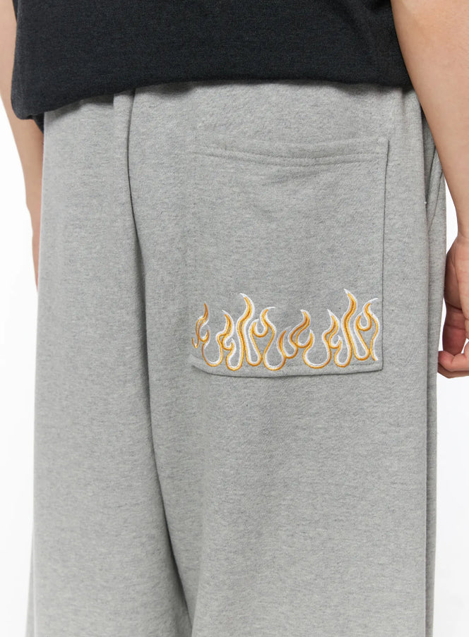 Men's Flame Wide Sweatpants (Gray) IL514 Gray close-up detail of golden flame embroidery on back patch pocket with heathered fleece texture
