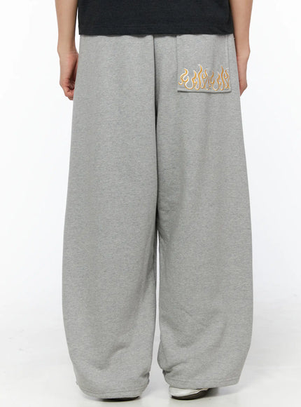 Men's Flame Wide Sweatpants (Gray) IL514 Gray back shot on model showing oversized wide-leg silhouette flame embroidered back pocket and hem detail