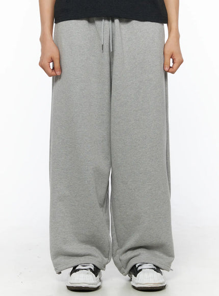 Men's Flame Wide Sweatpants (Gray) IL514 Gray front close-up on model showing wide-leg cut drawstring elastic waistband and heathered cotton fleece fabric