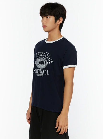 Men's Football Graphic T-Shirt IL513 Dark blue side shot on model showing white contrast ringer collar and sleeve trim with cotton fabric texture
