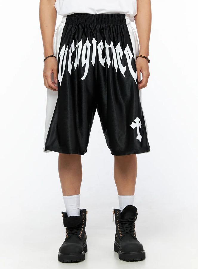 LEWKIN Men's Gothic Print Athletic Shorts IL515 Black front view on model with white gothic Vengeance lettering and cross print, elastic waistband, satin mesh fabric